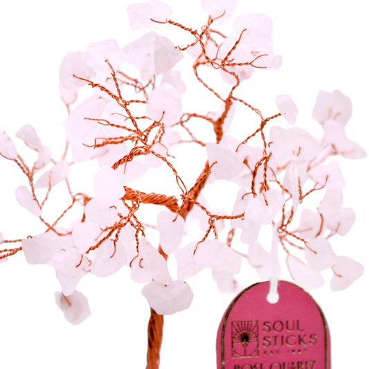 Decorative branch with pink flowers and orange twigs, branded 'Soul Sticks'.