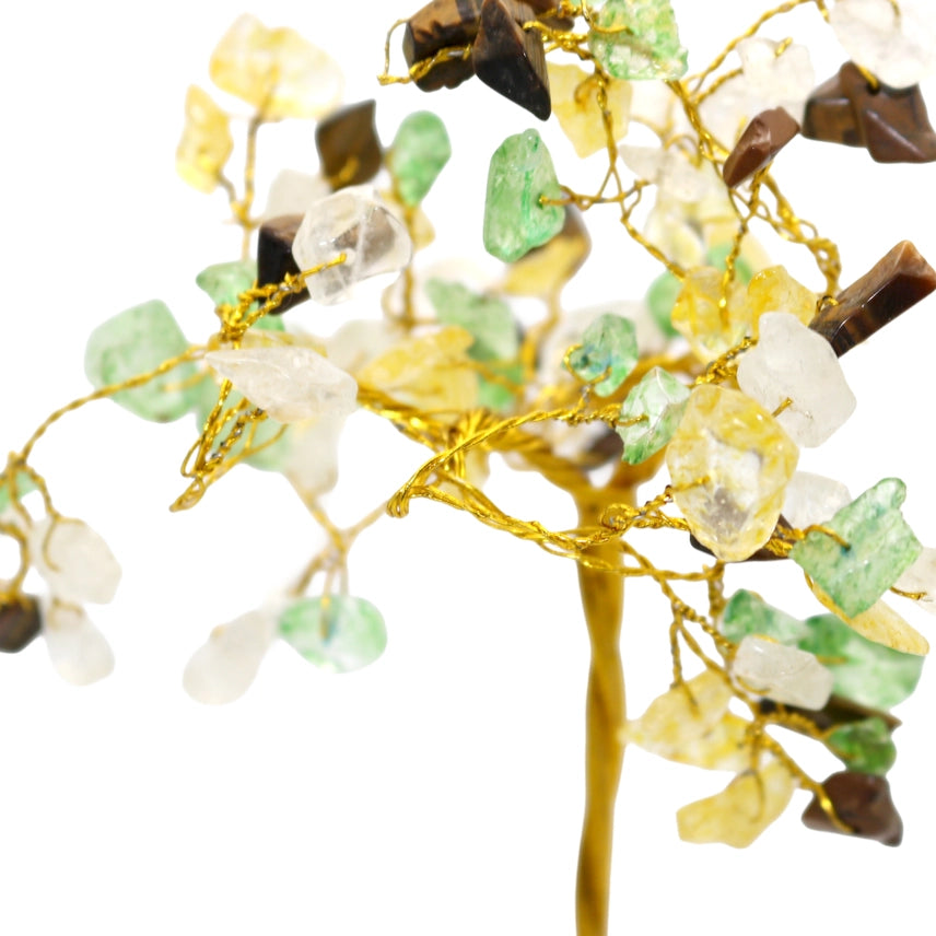 Decorative branch with stones and gold wire on a white background