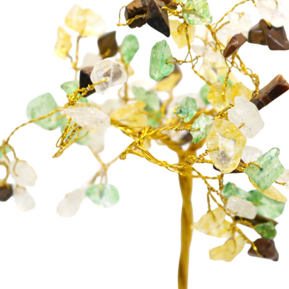 Decorative branch with stones and gold wire on a white background